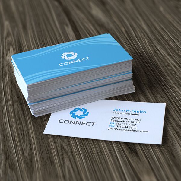A stack of blue business cards with “connect” logo and one card underneath showing the other side with contact information